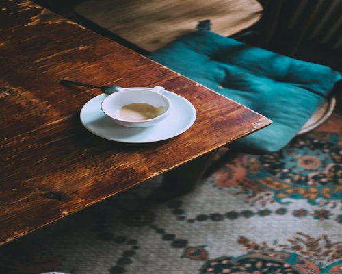 A warm cup of tea resting on a wooden table